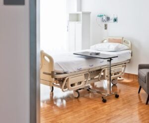 Private patient recovery room with hospital bed